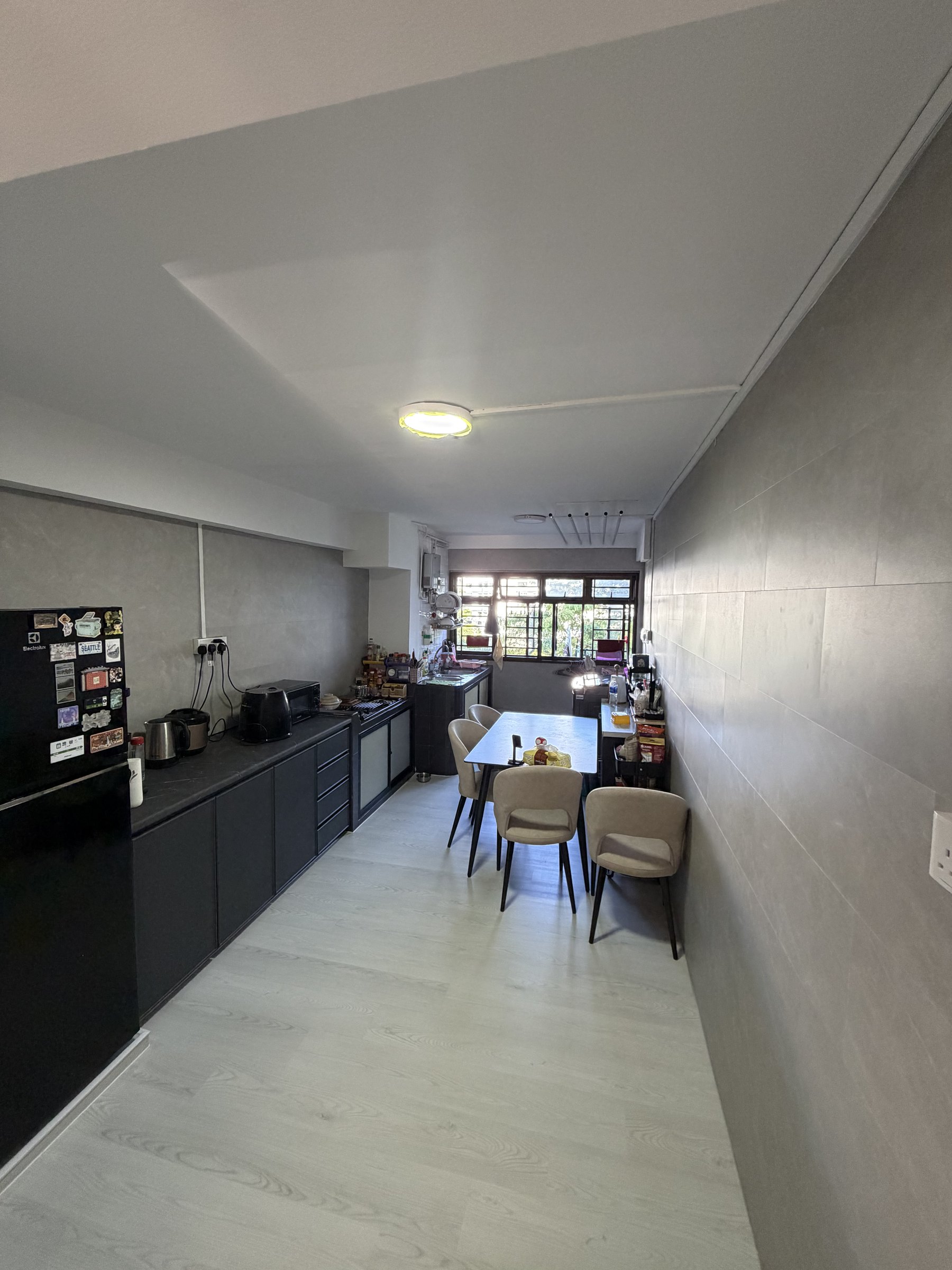 Light grey wood vinyl flooring in a completed Singapore kitchen