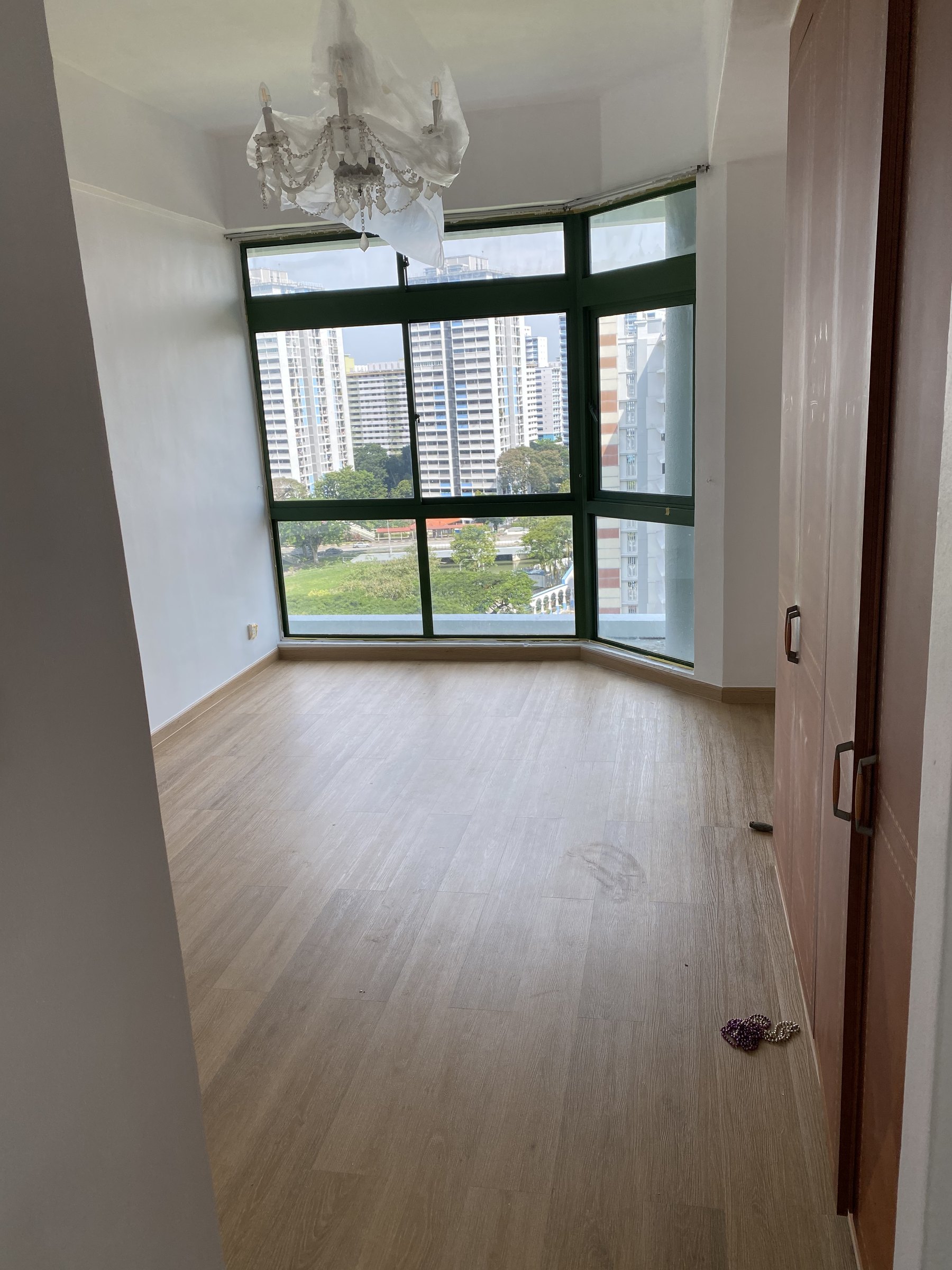 Light grey wood-look vinyl flooring in a Singapore bedroom