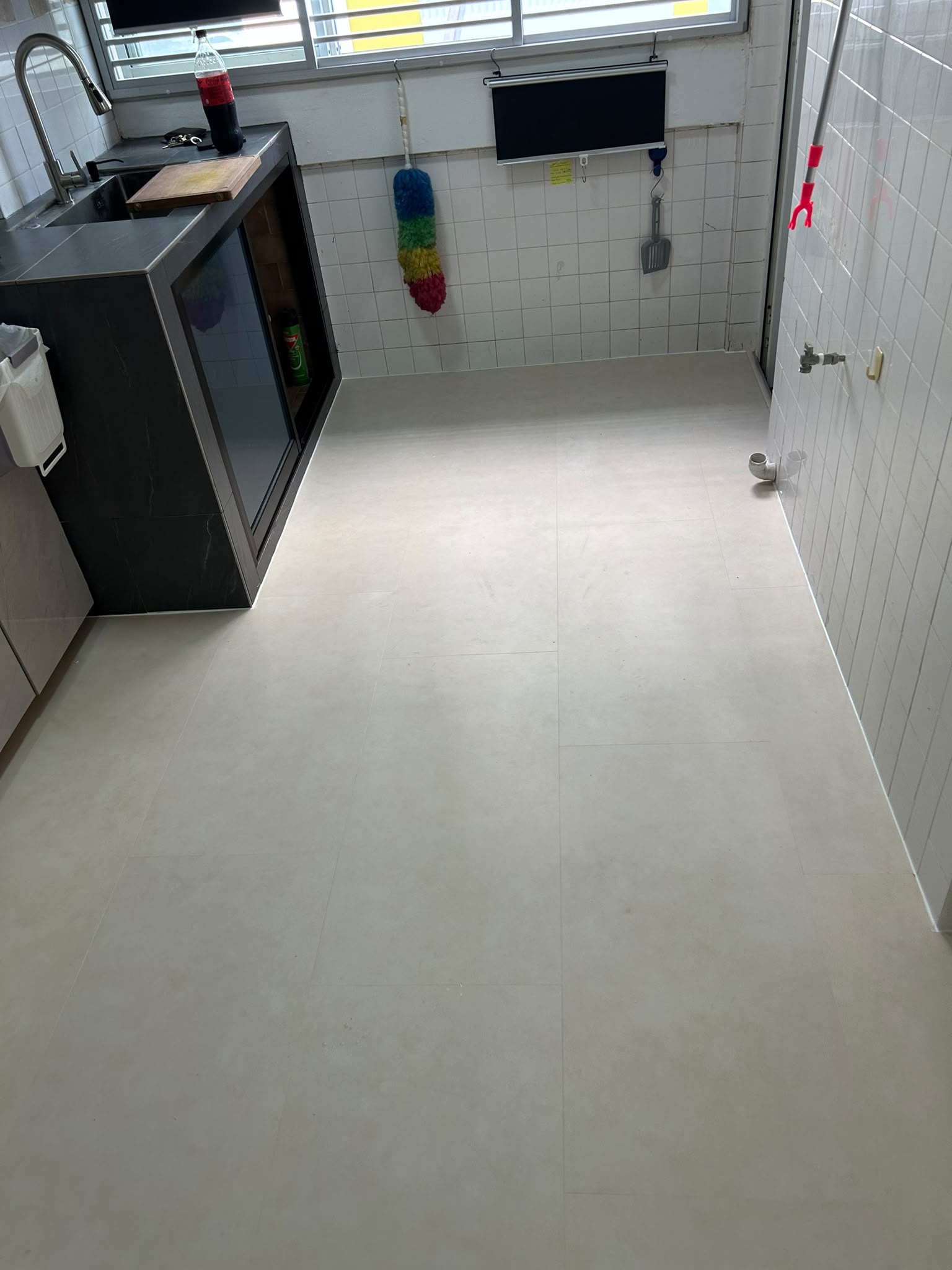 Light stone look vinyl flooring in a completed kitchen
