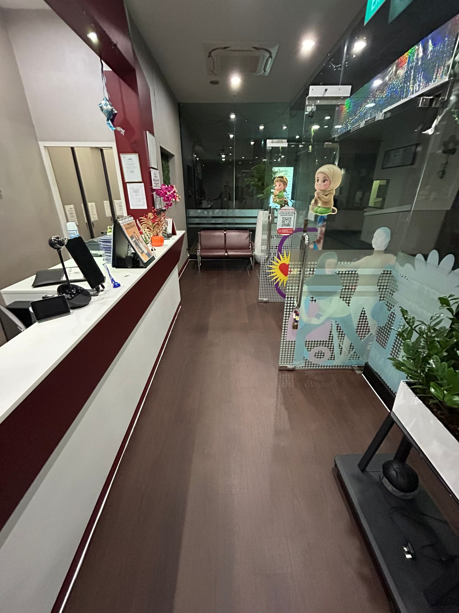 Warm brown wood-look vinyl flooring in a Singapore commercial reception