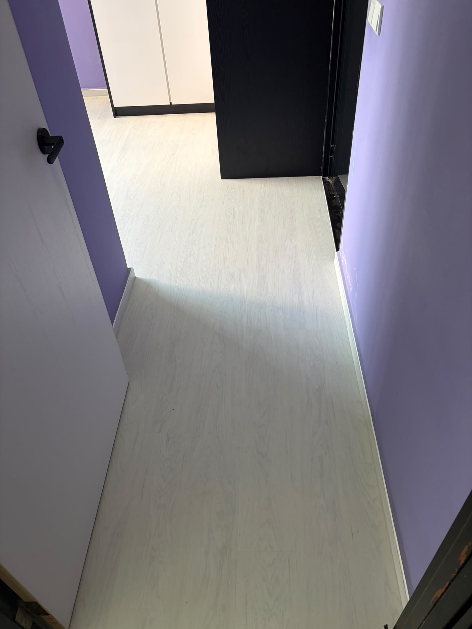 White wood look vinyl flooring through a bright corridor